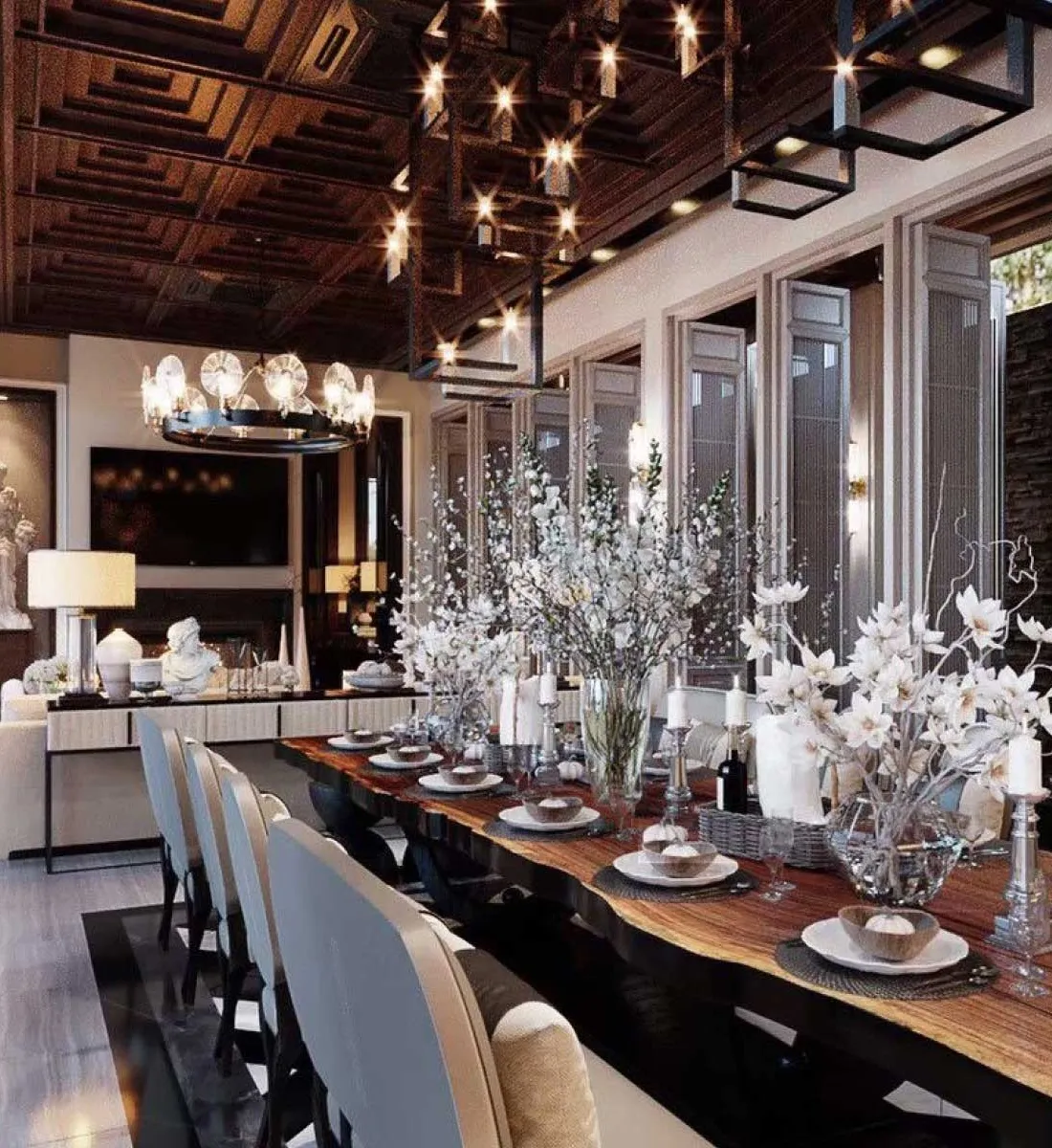 Long dining hall with blossom centrepieces and crystal chandeliers