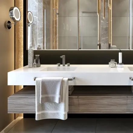 Marble bathroom vanity with a round mirror