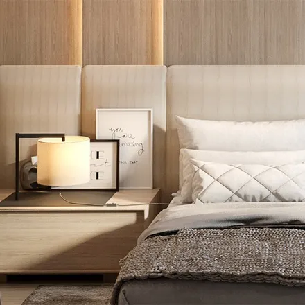 Warm bedroom with upholstered headboard and brass lamp